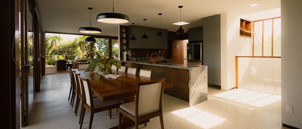 Bright and airy minimalist kitchen with clean countertops and natural light streaming through a window, evoking a sense of...