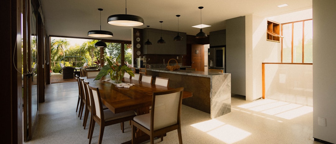 Bright and airy minimalist kitchen with clean countertops and natural light streaming through a window, evoking a sense of...