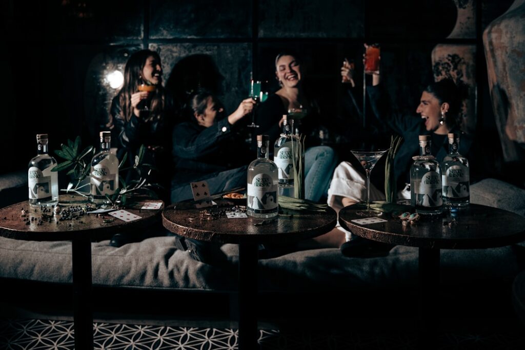 Diverse group of friends gathered around a beautifully set dinner table, laughing and enjoying a meal together in a space ...