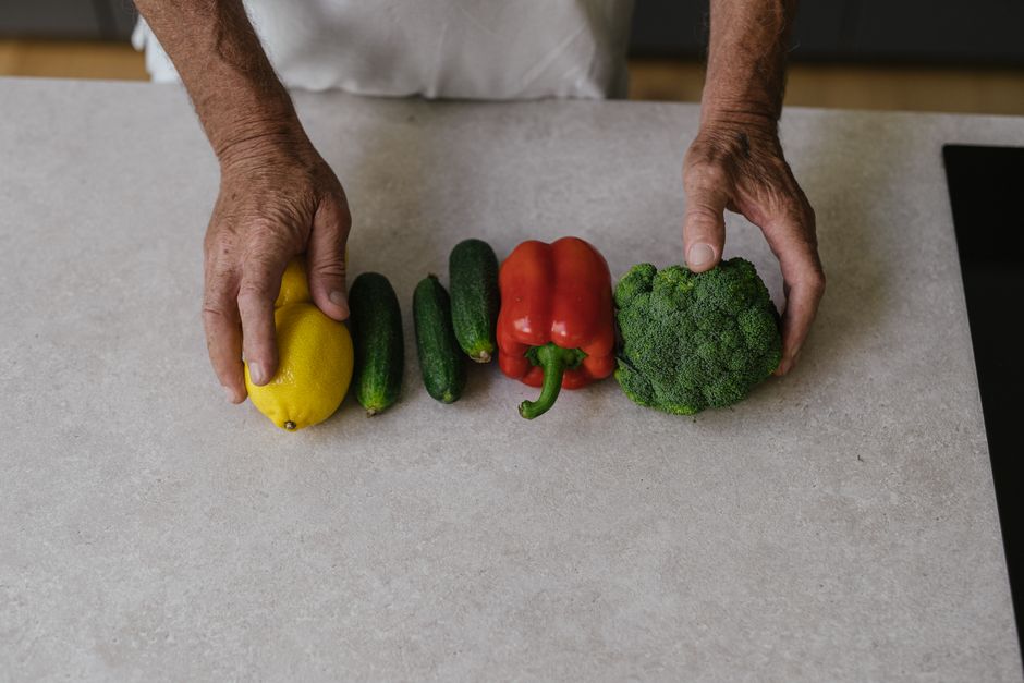 A bright and clean minimalist kitchen with fresh vegetables on the counter, representing the dream home sanctuary made possible by saving money on commissions.