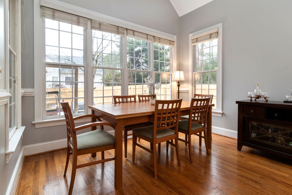 View from inside a calm, peaceful living room looking out a large, clean window, symbolizing a quiet sanctuary from the noisy outside world.